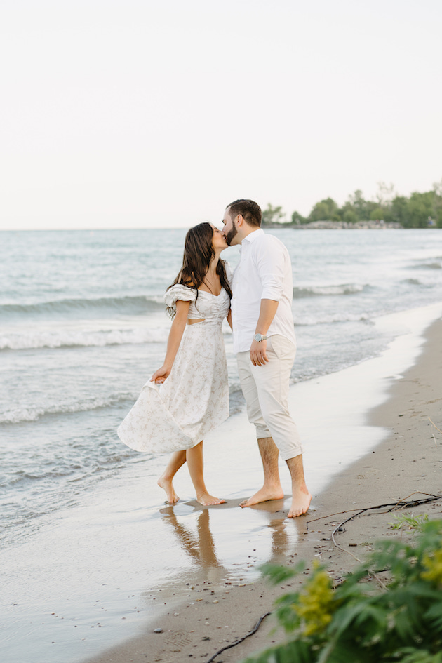 Couple kissing at Scarborough Bluffs for engagement session