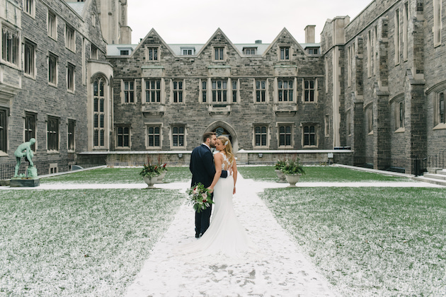 Couple kiss during their creative winter wedding photoshoot